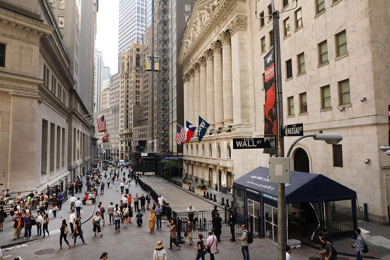 People walk outside of the New York Stock Exchange (NYSE) on May 29, 2018 in New York City.